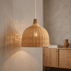Alba wicker lampshade lit, casting a warm pool of light below