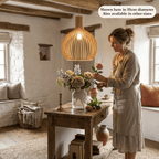 Aspen wooden lampshade in a bright room with a woman cutting flowers