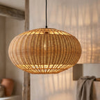 Isla wicker lampshade lit, casting a soft warm glow