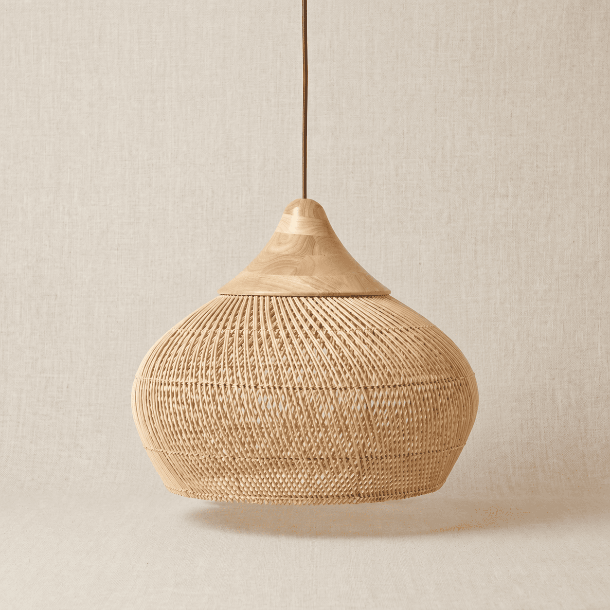 Mira handwoven wicker pendant lampshade on a neutral background