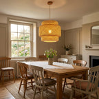 Noa rattan ceiling light hanging in a cosy British dining room