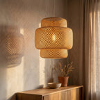 Noa rattan ceiling light glowing warmly, casting soft shadows