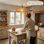 The Rowan wooden lampshade in a bright kitchen with a woman cooking