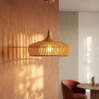 Rowan wooden lampshade lit, casting a warm glow and soft shadows