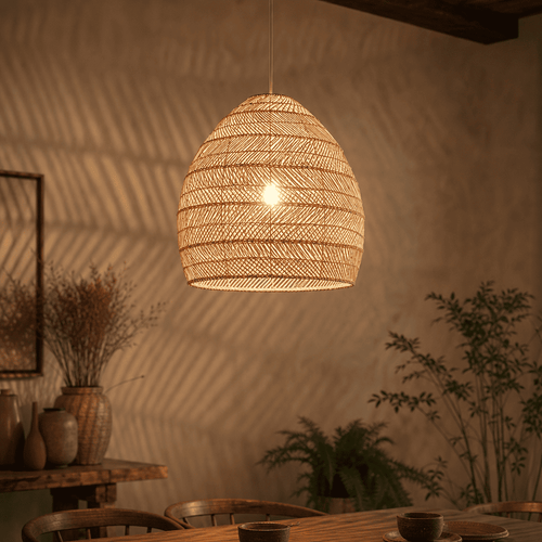 Sena wicker lampshade glowing warmly, casting soft shadows on the wall