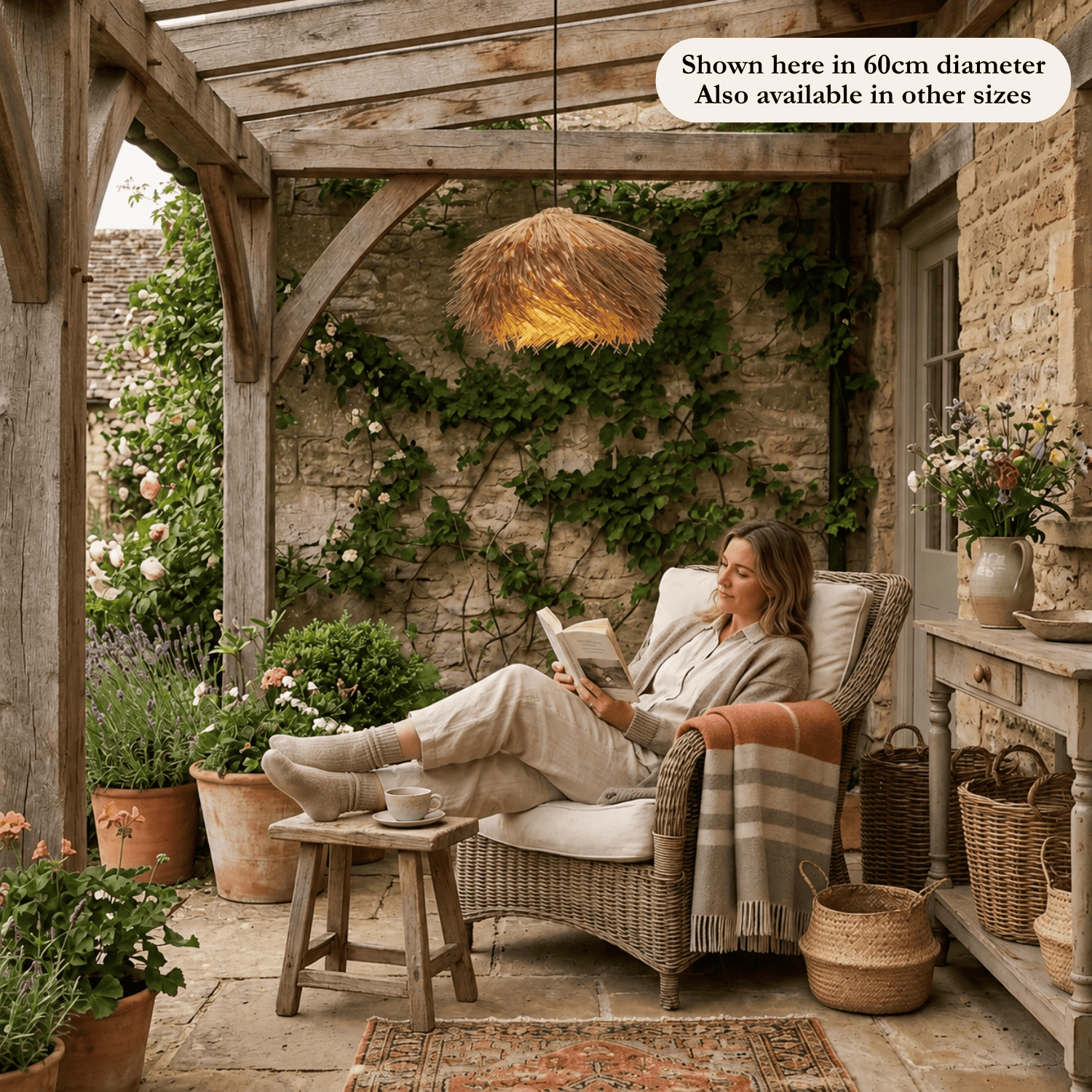 Vega straw lampshade in an exterior with a woman reading in an armchair