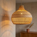 Vera rattan lampshade lit, casting soft vertical lines of light