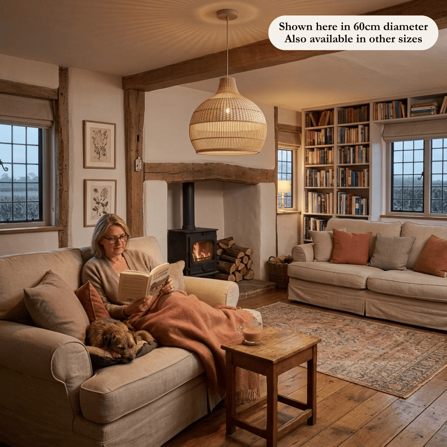 Vera rattan lampshade hanging above a couch with a woman reading with her dog beside.